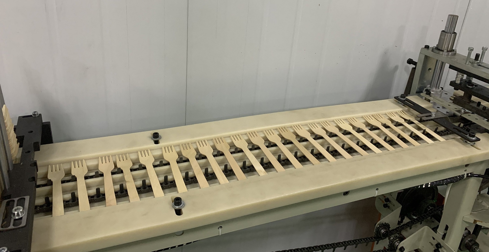 Logo printing on wooden cutlery at the factory