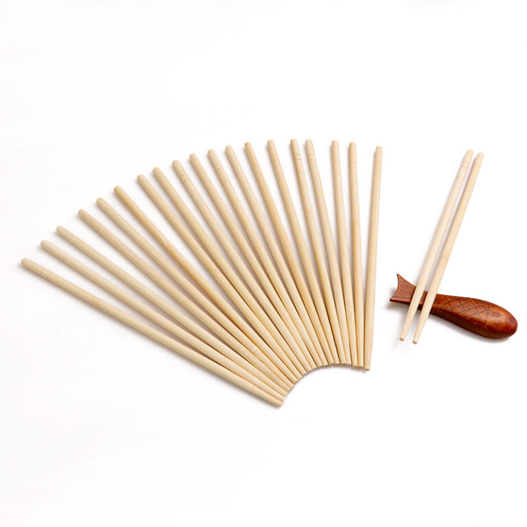 Round bamboo chopsticks fanned out beside a single pair holding a piece of food