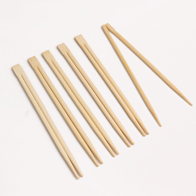 Twins bamboo chopsticks still joined at the top next to a pair snapped apart for use