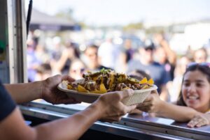 EcoWareTech-sugarcane-bagasse-food-boat-holding-loaded-nachos-with-melted-cheese-jalapenos-and-beans