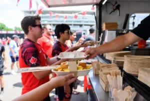 Food-truck-serving-poutine-in-certified-compostable-bagasse-food-boats-with-FSC-wooden-cutlery-at-a-Canada-World-Cup-2026-fan-festival