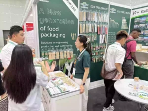 B2B buyers inspecting oil-resistant sugarcane bagasse containers at Ecoware Booth 2903 during MIFB 20262