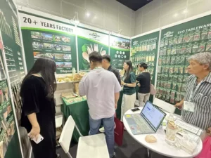 B2B buyers inspecting oil-resistant sugarcane bagasse containers at Ecoware Booth 2903 during MIFB 2026 1
